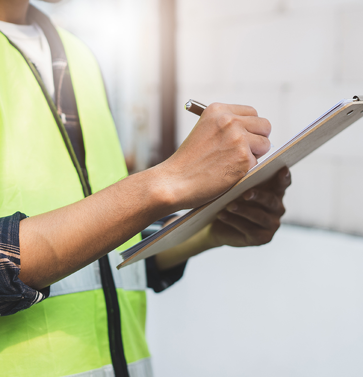 Worker reviewing a checklist on a clipboard