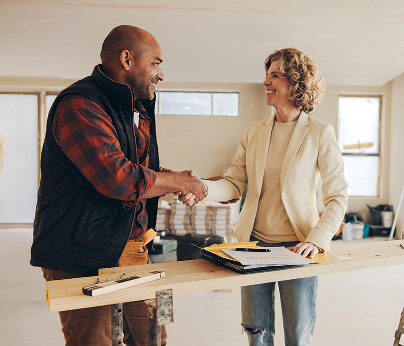 Contractor and customer shaking hands at a job site